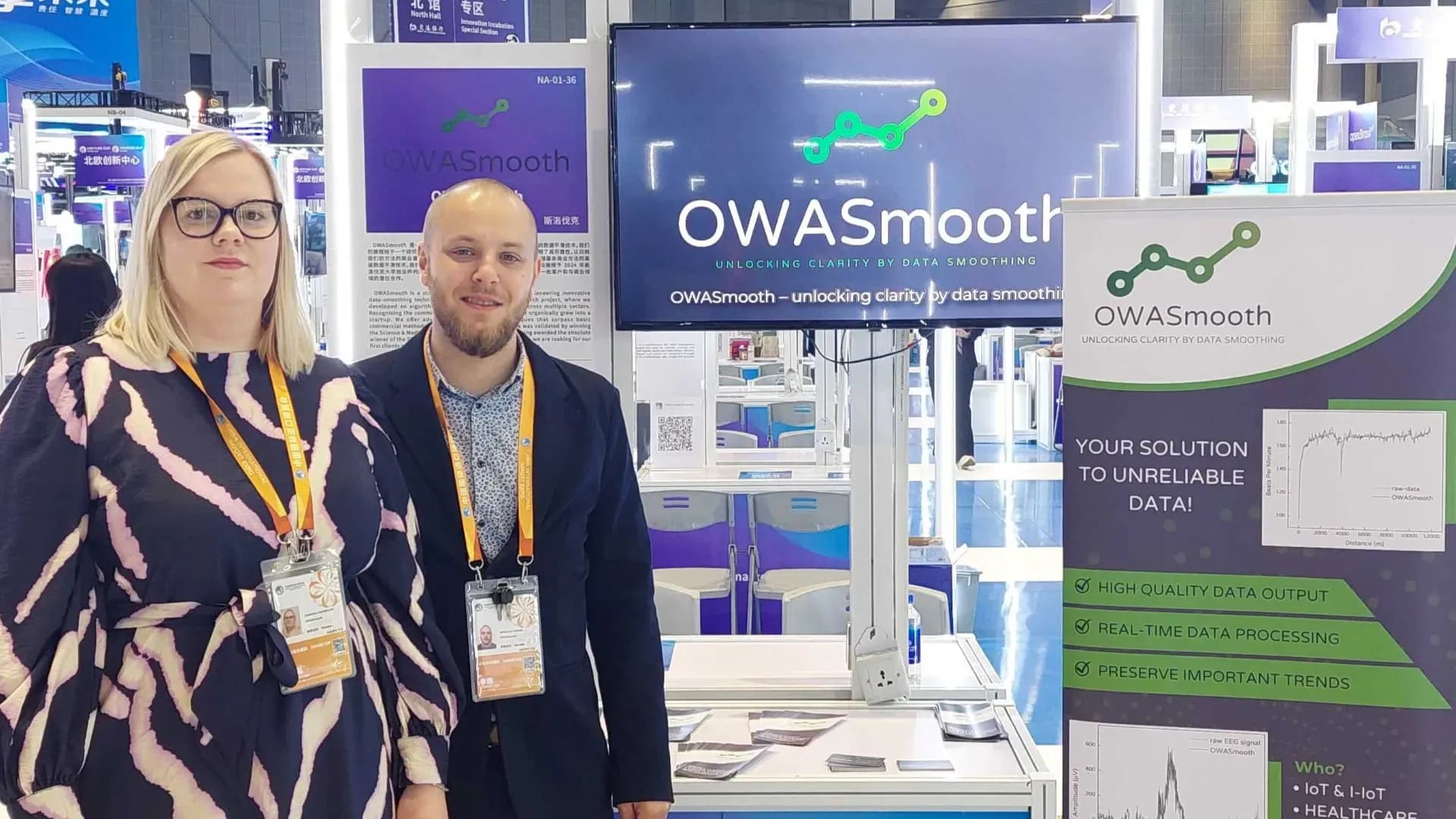 Founders Miro and Baska standing and smiling with the OWASmooth and a white boot behind them